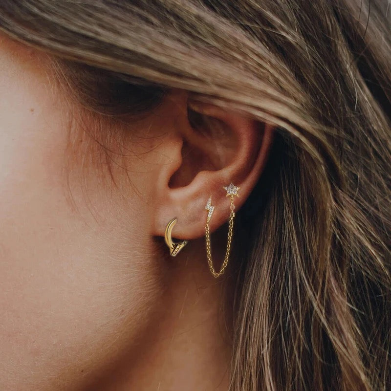 Piercing cadena con estrella y rayo
